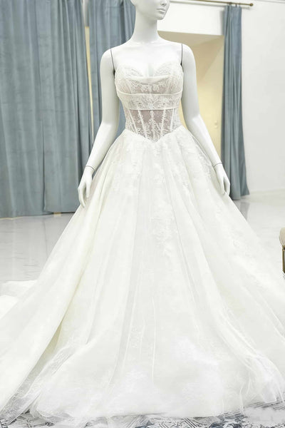 White wedding dress on a mannequin against a neutral background