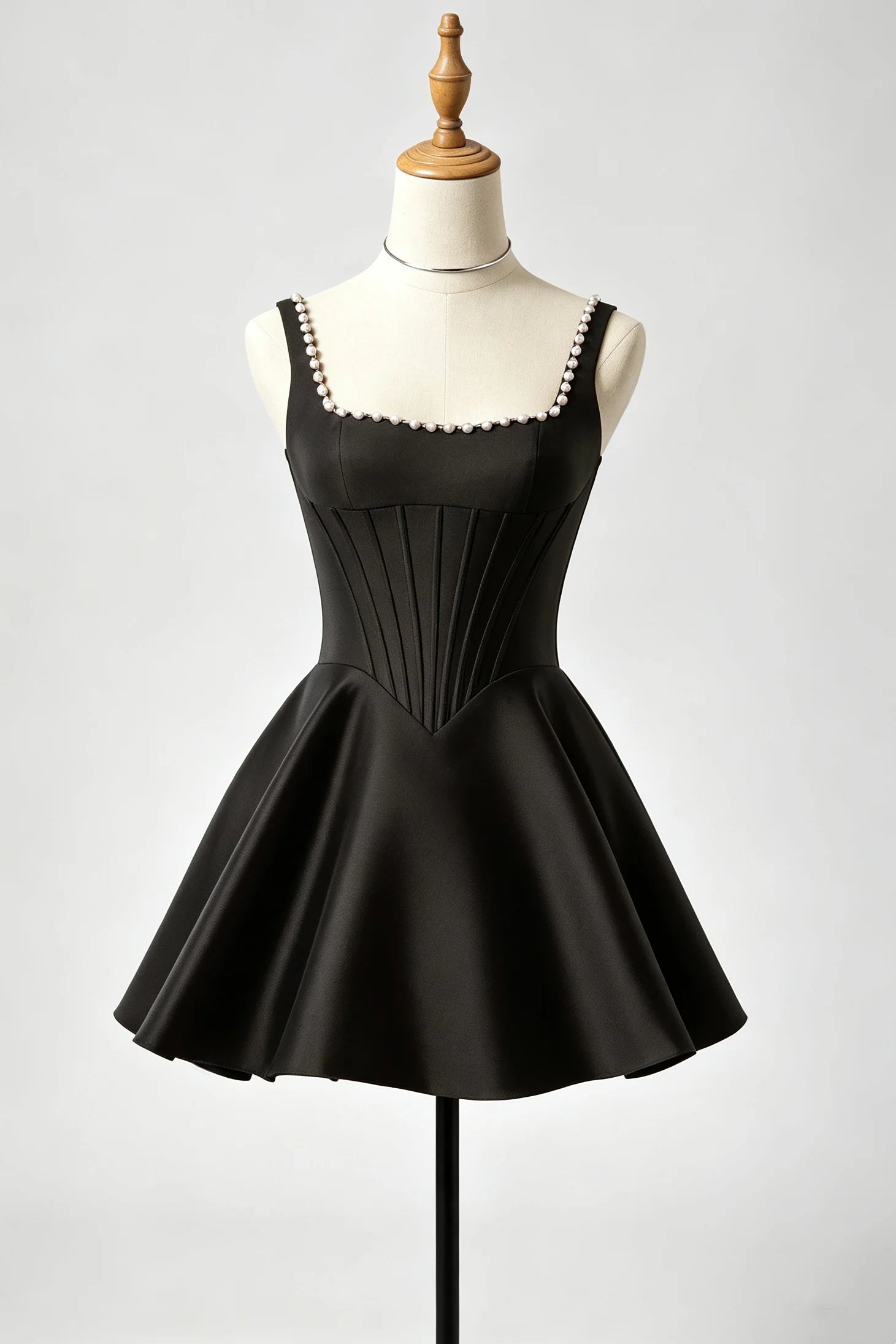 A black sleeveless fit-and-flare homecoming dress with a pleated corset-style bodice and flared skirt.