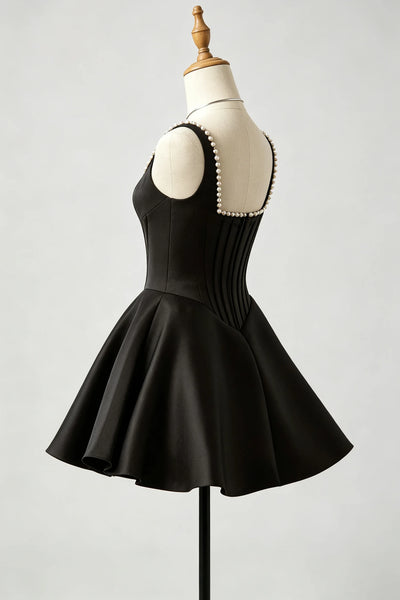 A black sleeveless fit-and-flare homecoming dress with a pleated corset-style bodice and flared skirt.