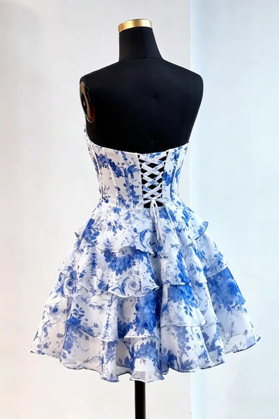 Blue and white floral dress on a mannequin against a white background