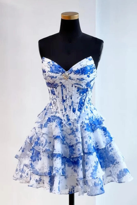 Blue and white floral dress on a mannequin against a white background