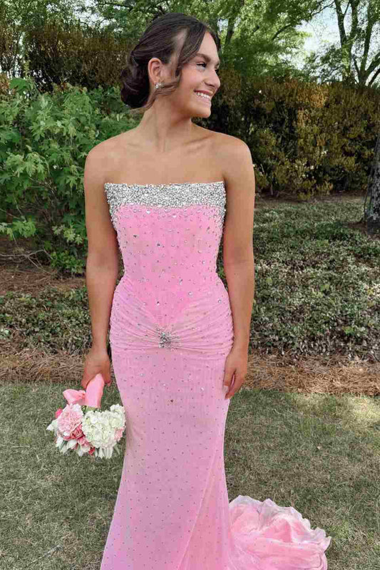 Young woman wearing blush pink rhinestone strapless mermaid prom dress