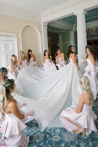 Blush pink strapless peplum satin bridesmaid dress with side slit