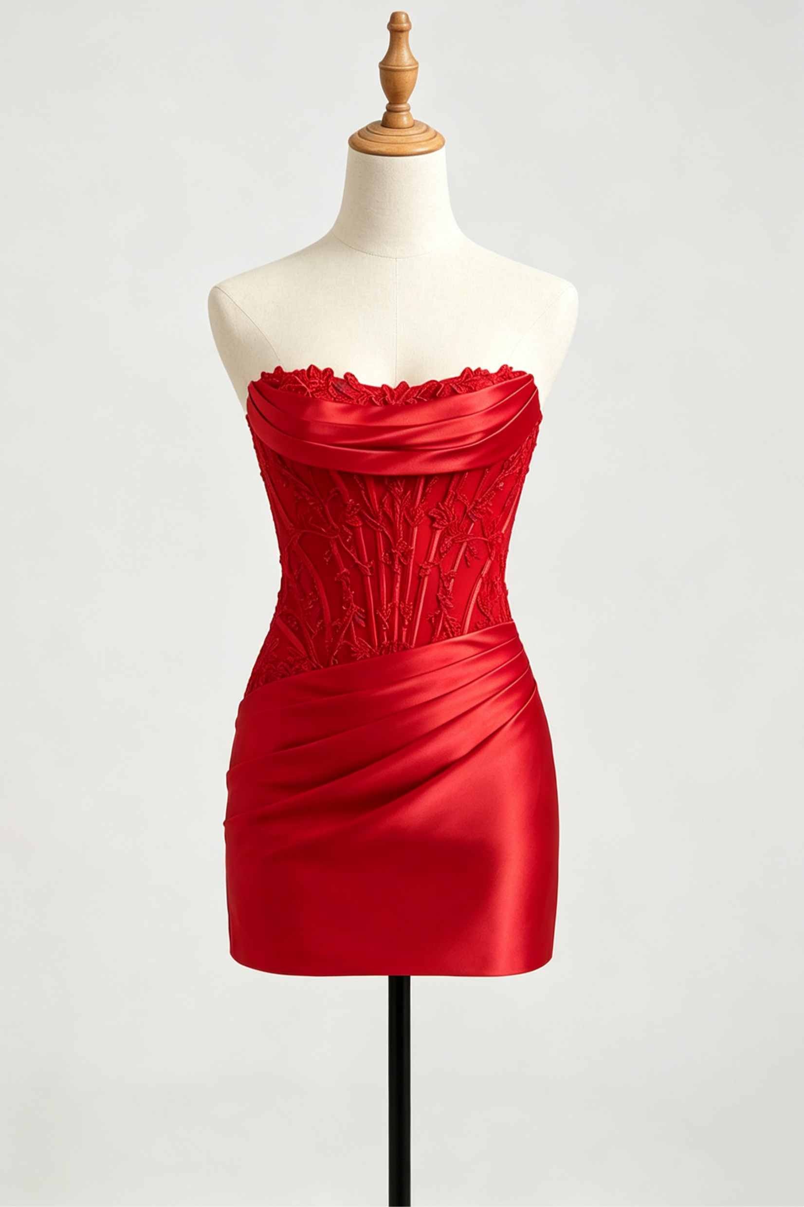 A red strapless taffeta homecoming dress with a ruched corset bodice and scalloped neckline, displayed on a cream mannequin torso with a wooden neck cap against a light gray background.