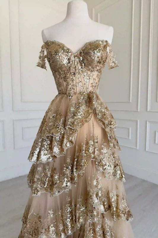 Close-up of sequin embellishments on gold off shoulder bodice