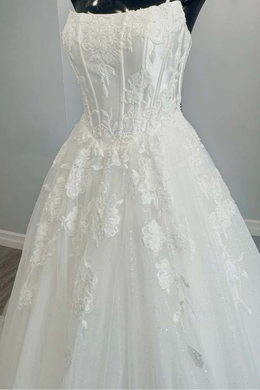 Close-up of delicate appliqué detailing on ivory tulle bodice