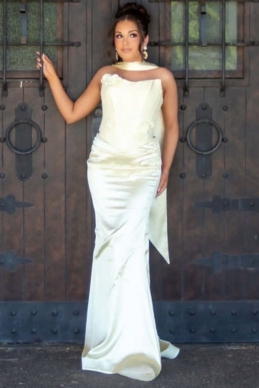 A woman wearing a strapless ivory satin mermaid gown with a draped neckline.