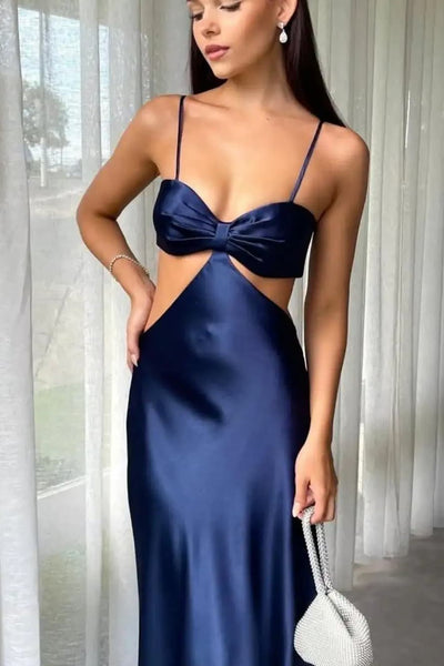 Woman in a blue evening gown taking a mirror selfie in a well-lit room.