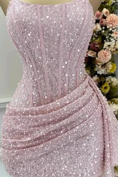 Pink sequin dress on a mannequin with a floral background