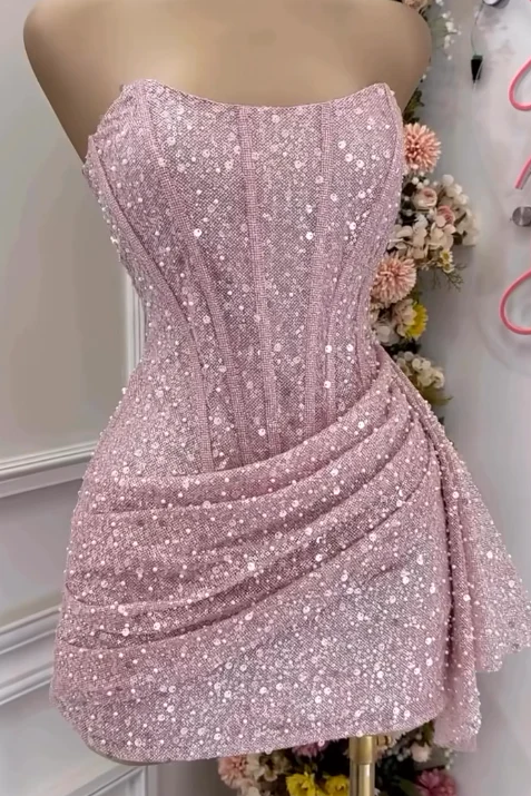 Pink sequin dress on a mannequin with a floral background