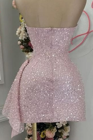 Pink sparkly dress on a mannequin with flowers in the background