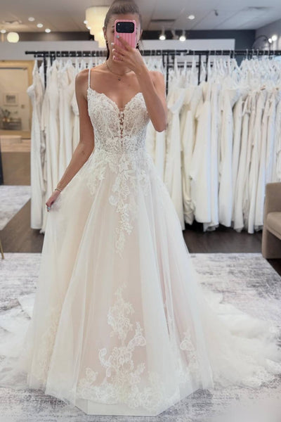 Woman wearing a white lace wedding dress.