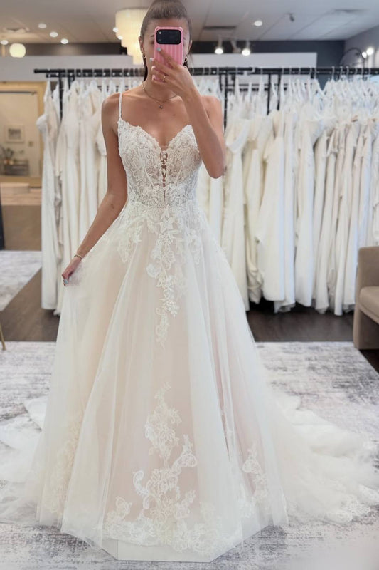 Woman wearing a white lace wedding dress.