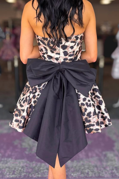 Woman wearing a leopard print dress in an indoor setting
