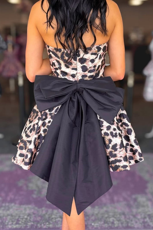 Dress with leopard print top and black bow skirt, worn by a person.