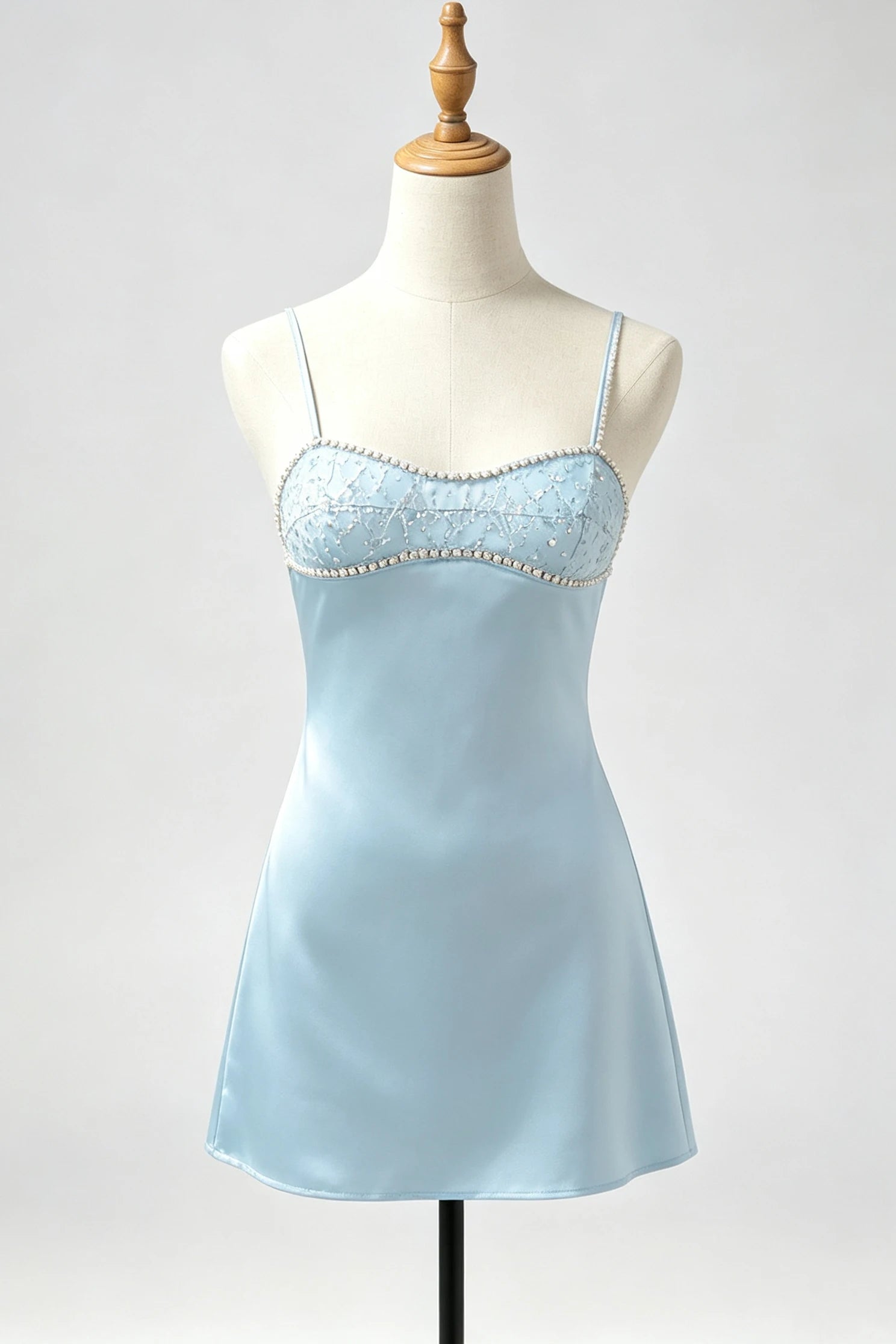 A light blue satin slip dress with thin straps and a lace-trimmed bust adorned with small pearls, displayed on a cream mannequin against a light gray background.