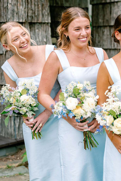 Side view of light blue sheath dress showing square neckline and wide straps