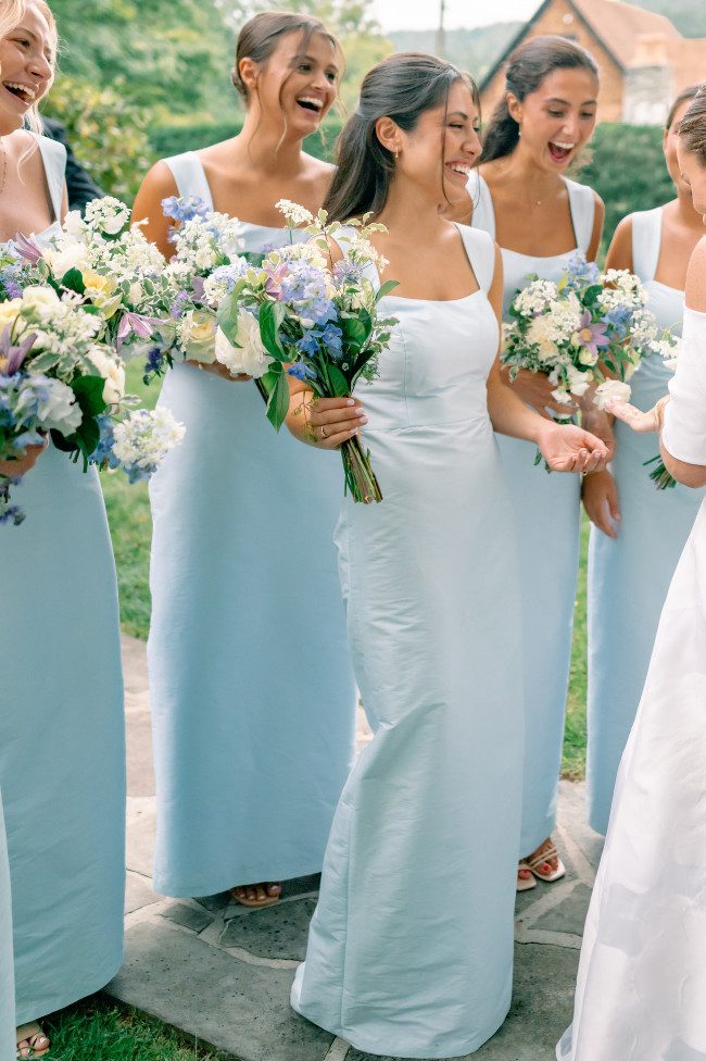 Side view of light blue sheath dress showing square neckline and wide straps