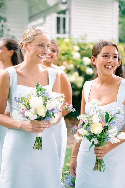 Side view of light blue sheath dress showing square neckline and wide straps
