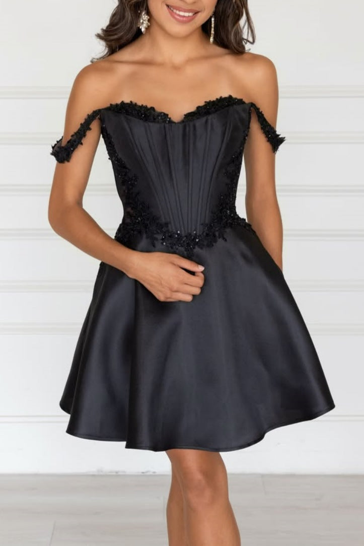 Black strapless dress with floral details on a white background
