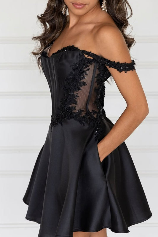 Black dress with floral lace details on a white background
