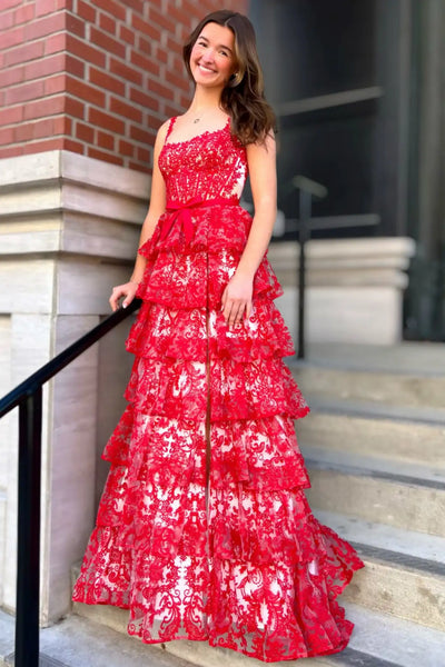 Woman wearing red lace spaghetti strap tiered ruffle high slit prom evening gown