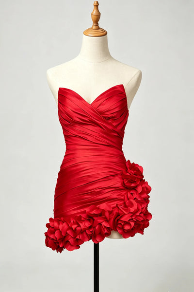 A red strapless sweetheart dress with ruched fabric and large ruffled floral details at the hem.