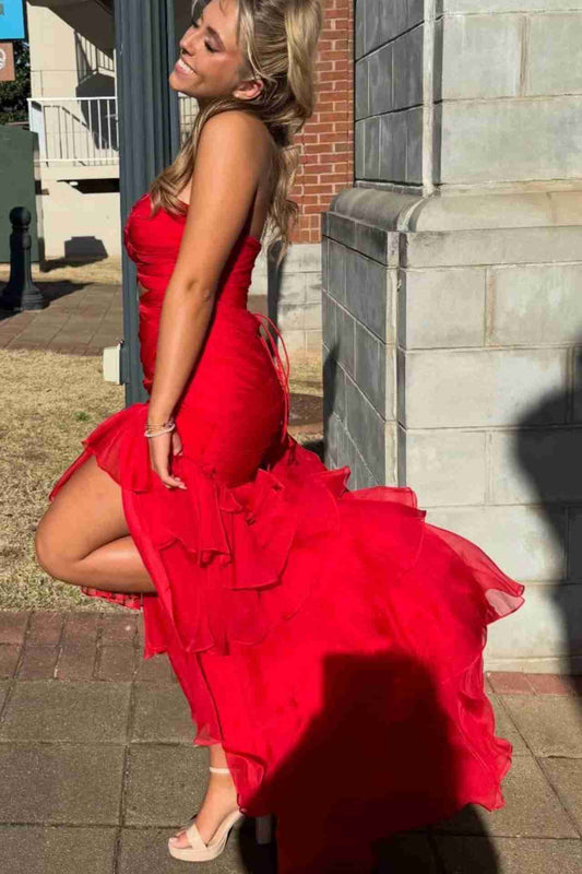 Side view of red mermaid prom dress showing cutout waist detail
