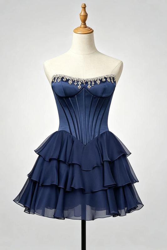A navy blue strapless homecoming dress displayed on a cream mannequin torso.
