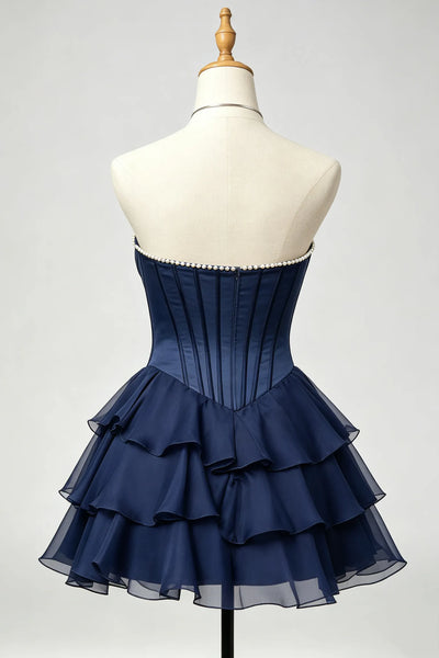 A navy blue strapless homecoming dress displayed on a cream mannequin torso.