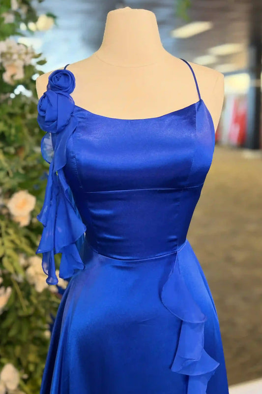 A royal blue dress displayed on a mannequin, featuring a ruffled fabric detail on the shoulder and a matching ruffle at the waist.