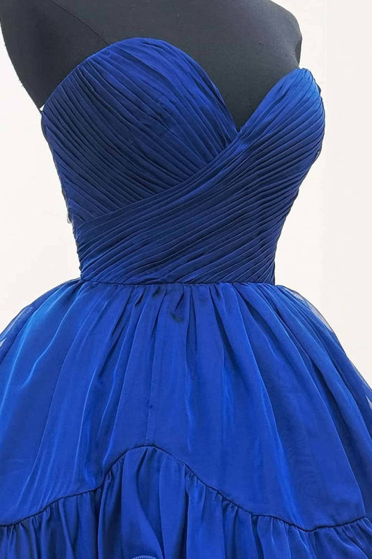Close-up of pleated bodice detail on royal blue strapless dress