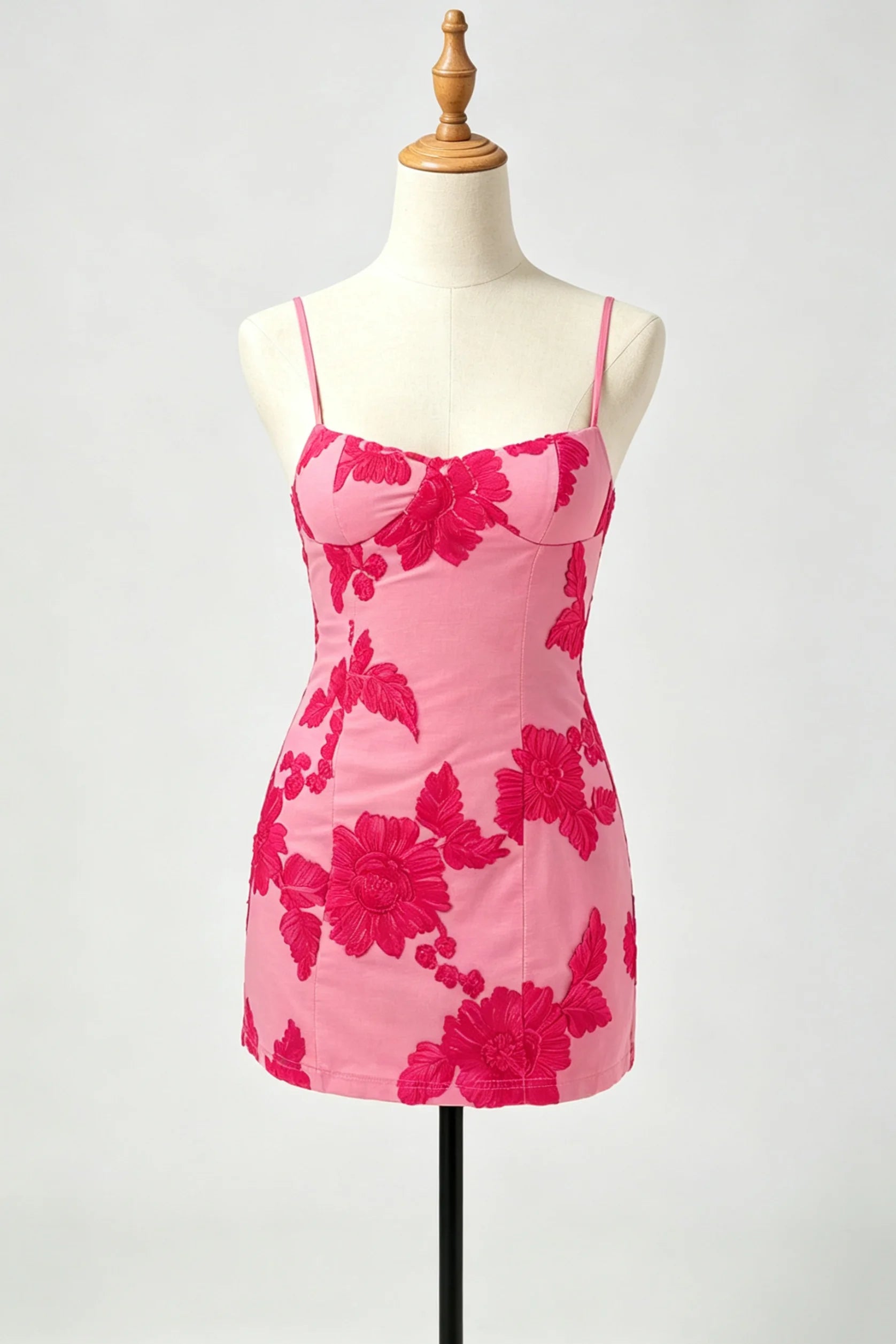 A pink homecoming dress with a bold dark pink floral pattern.