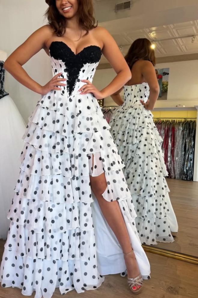 Strapless black polka dot tiered chiffon prom gown with high slit