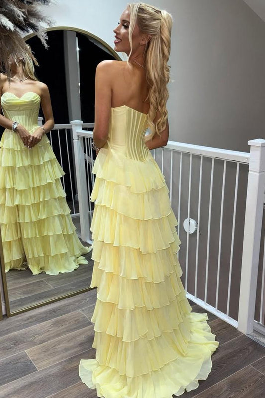 Back view of yellow strapless tiered chiffon prom dress