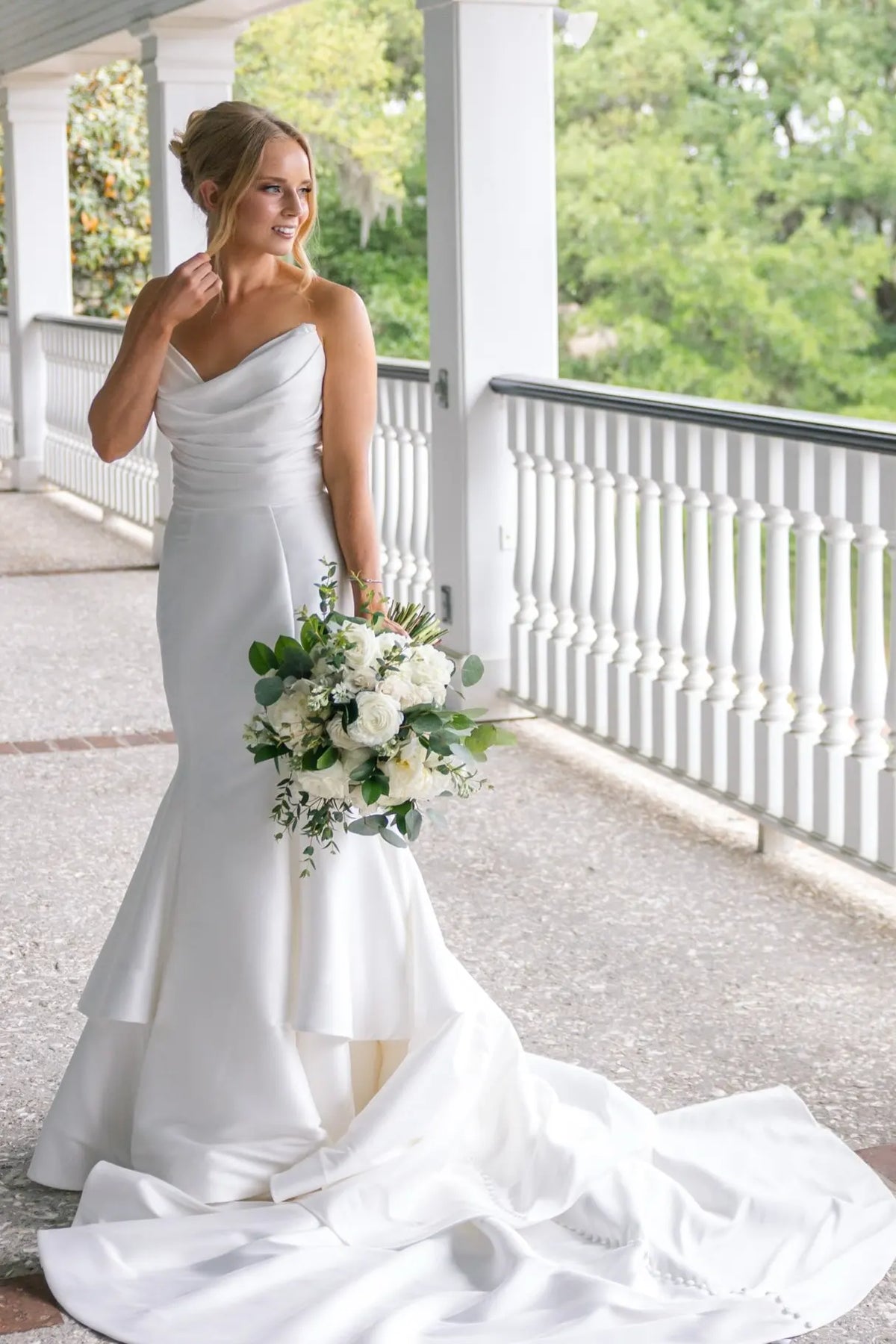 V-neck satin mermaid wedding dress with layered skirt and chapel train