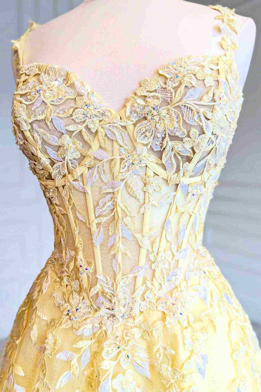 Close-up of appliqué embellishments on yellow tulle bodice