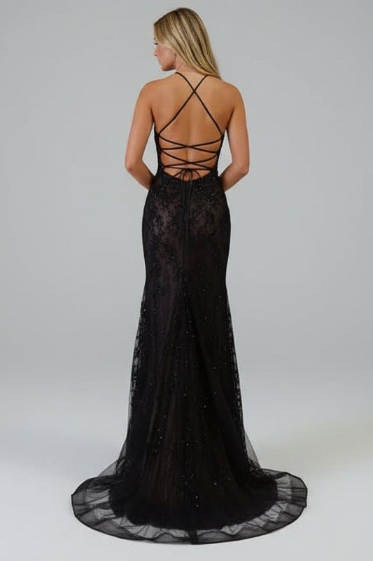 Woman wearing a black lace evening gown with a white background