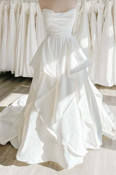 Ethereal ruffle white satin wedding gown with sweetheart neckline and cascading ruffles on the skirt, front view