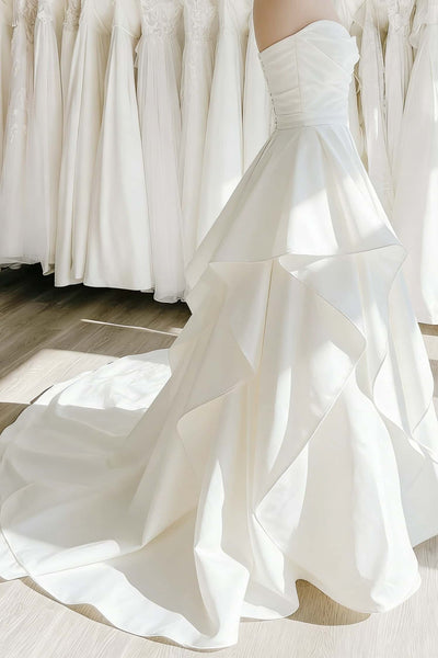 Ethereal ruffle white satin wedding gown with sweetheart neckline and cascading ruffles on the skirt, front view